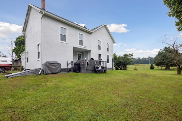 rear view of house with a yard