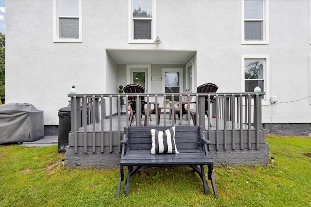 exterior space featuring a deck and a lawn