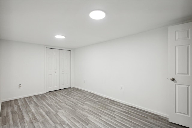 unfurnished bedroom featuring hardwood / wood-style flooring and a closet