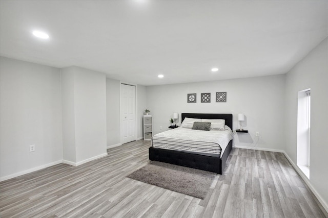 bedroom with a closet and hardwood / wood-style floors