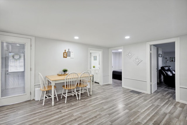 dining area with light hardwood / wood-style floors