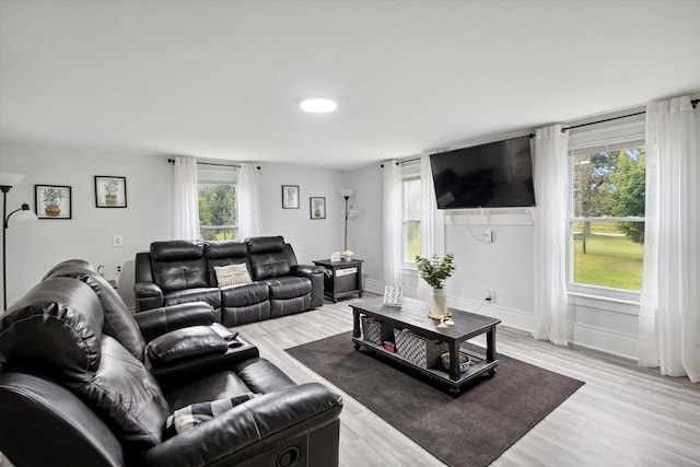 living room featuring light hardwood / wood-style flooring and a healthy amount of sunlight