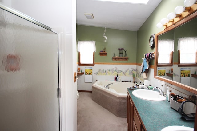 bathroom featuring vanity, lofted ceiling, and independent shower and bath