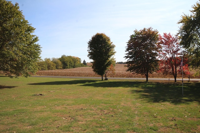 surrounding community with a lawn and a rural view