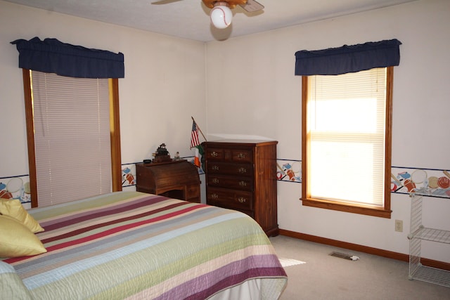 bedroom with ceiling fan and light colored carpet