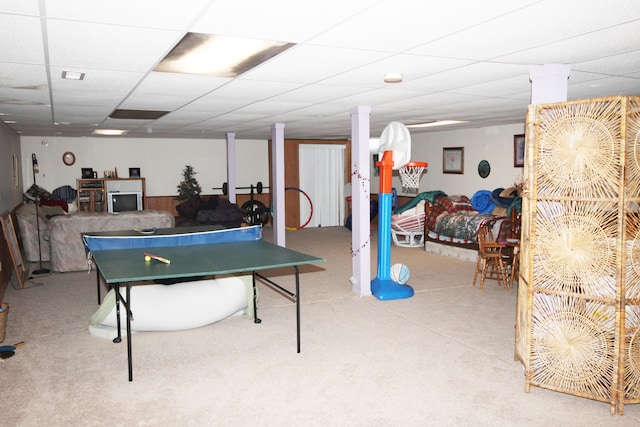 recreation room featuring carpet and a drop ceiling