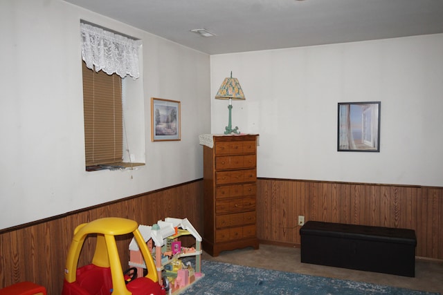 recreation room with wood walls