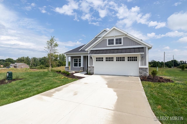 craftsman-style home with board and batten siding, concrete driveway, a front lawn, and a standing seam roof