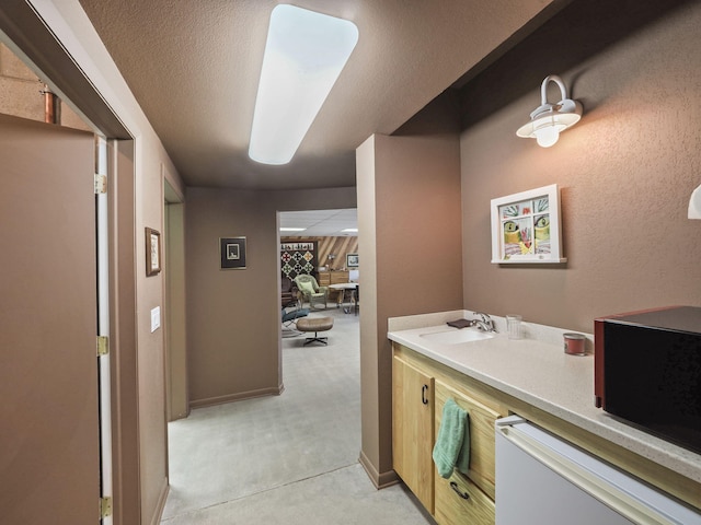 interior space featuring sink and a textured ceiling