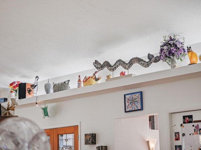 details with white fridge and a textured ceiling