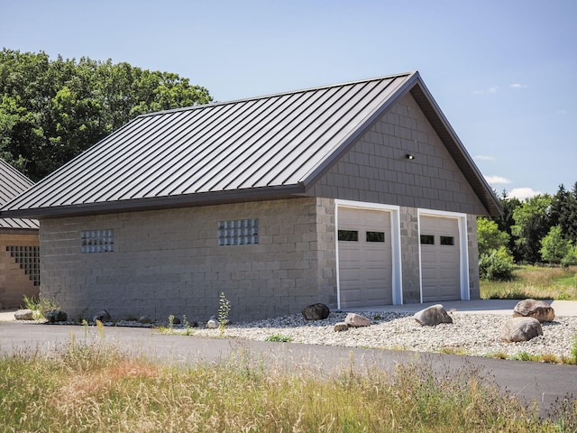 view of property exterior with an outbuilding and a garage