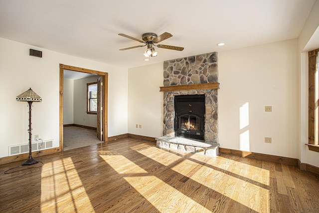 unfurnished living room with ceiling fan, wood-type flooring, and a fireplace