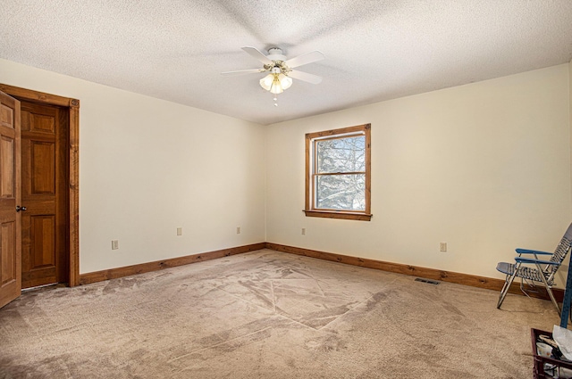 unfurnished room featuring carpet flooring, a textured ceiling, and ceiling fan