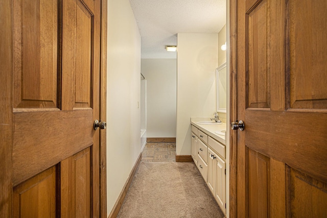 bathroom featuring vanity and a textured ceiling