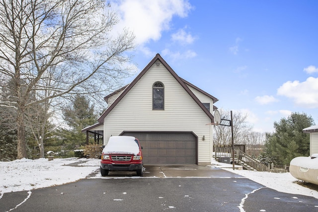 view of snow covered exterior with a garage