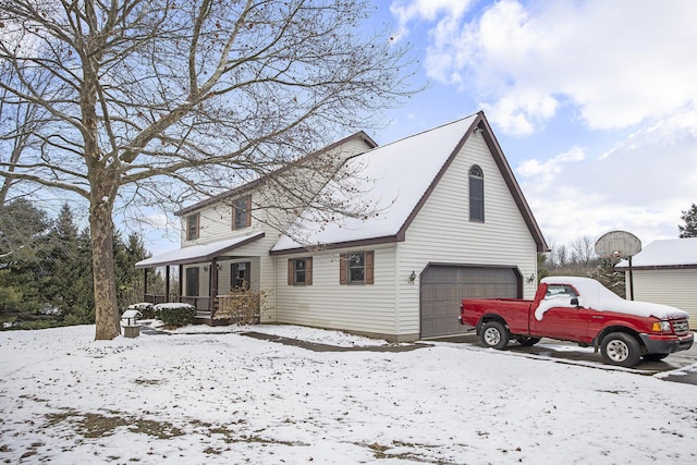 exterior space featuring covered porch and a garage