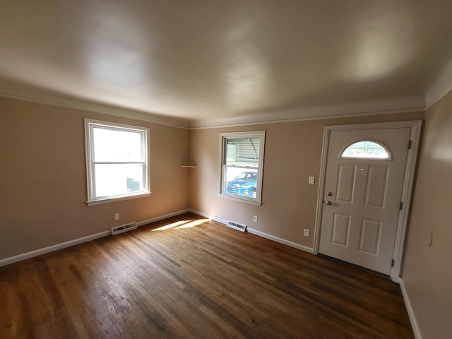 entrance foyer featuring dark hardwood / wood-style floors and crown molding