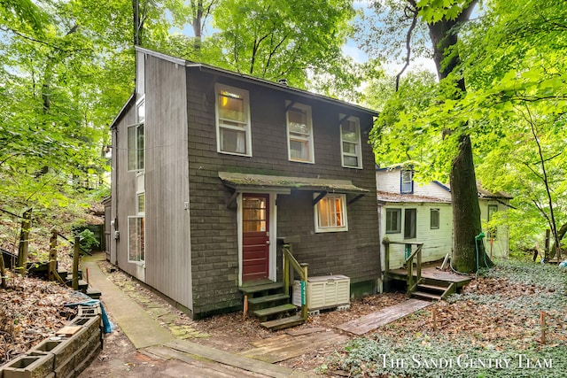 back of property featuring a wooden deck