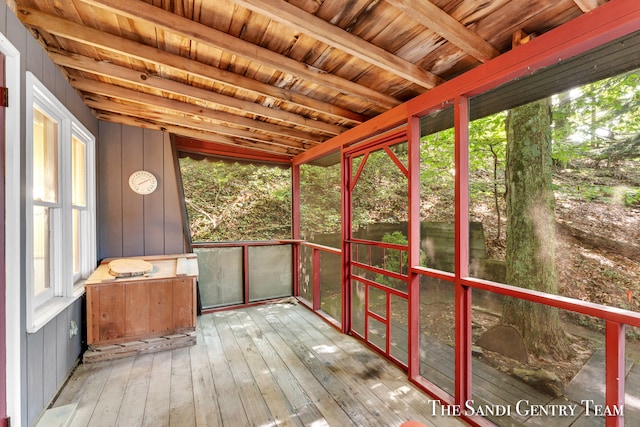 unfurnished sunroom with wooden ceiling and beam ceiling