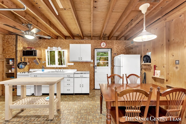 kitchen with sink, white cabinets, light tile patterned floors, white appliances, and ceiling fan