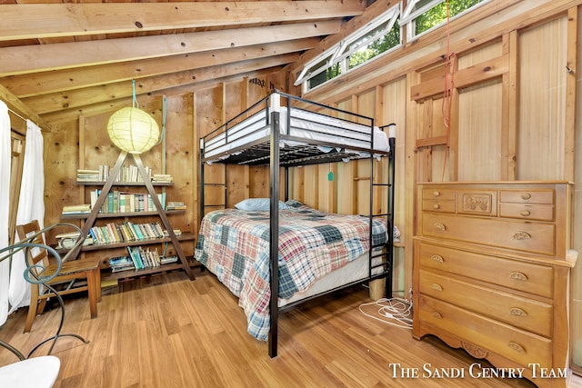 bedroom featuring light hardwood / wood-style flooring, wooden walls, and lofted ceiling with beams