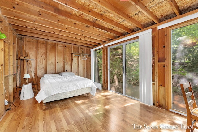 bedroom featuring light wood-type flooring and access to outside