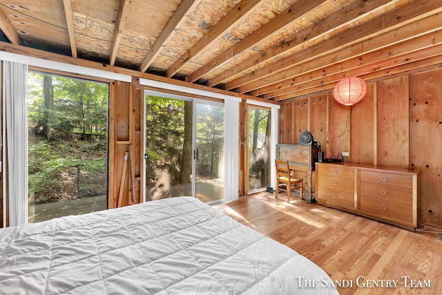 bedroom with light hardwood / wood-style flooring, multiple windows, and access to exterior