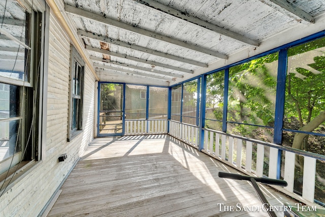 unfurnished sunroom with vaulted ceiling and a healthy amount of sunlight