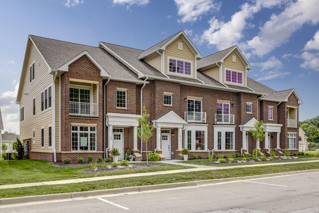 colonial inspired home with brick siding