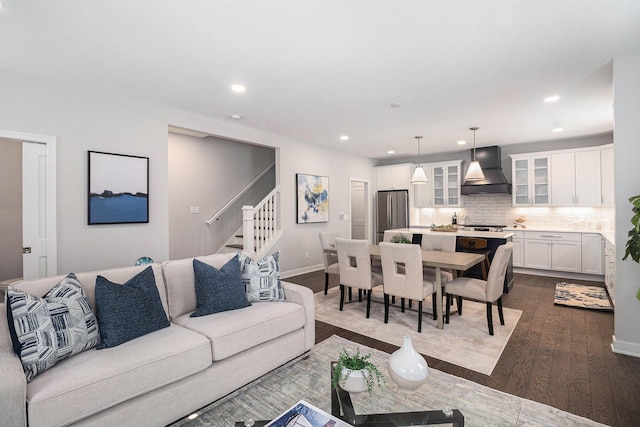 living area with stairs, baseboards, dark wood-style flooring, and recessed lighting