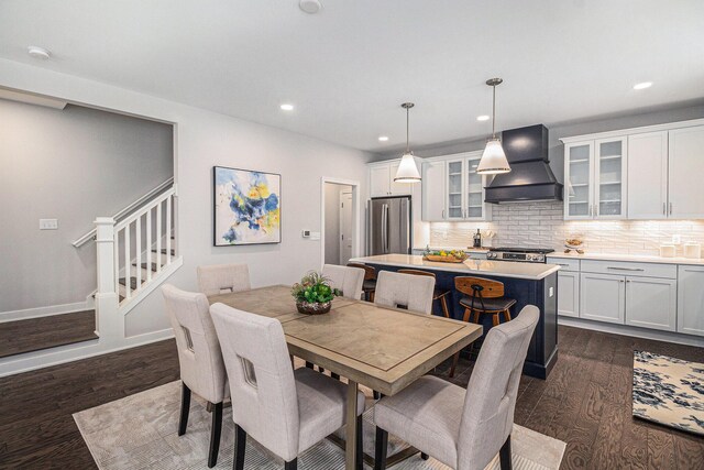 dining room featuring dark wood-style floors, baseboards, stairs, and recessed lighting