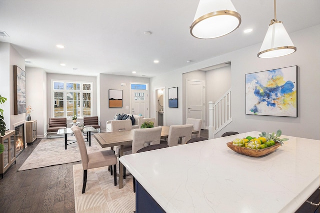 dining area featuring dark wood-style floors, stairs, visible vents, and recessed lighting