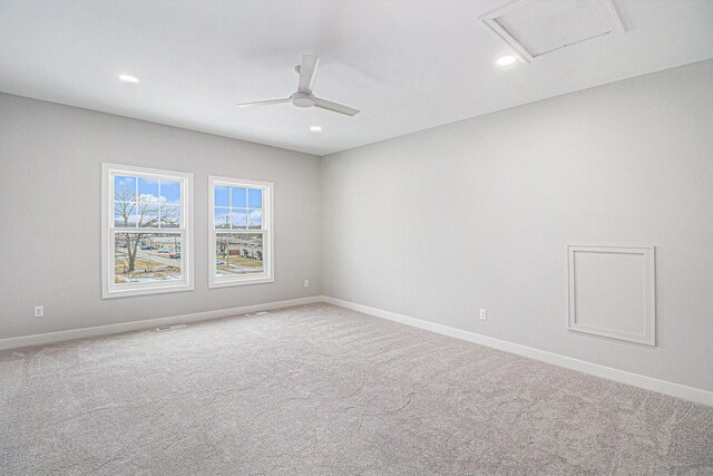 carpeted empty room featuring a ceiling fan, recessed lighting, attic access, and baseboards