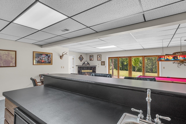 interior space with french doors and a paneled ceiling