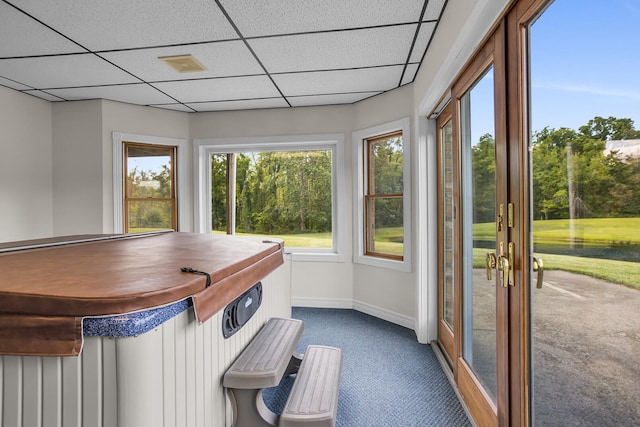 unfurnished sunroom with a paneled ceiling and a healthy amount of sunlight