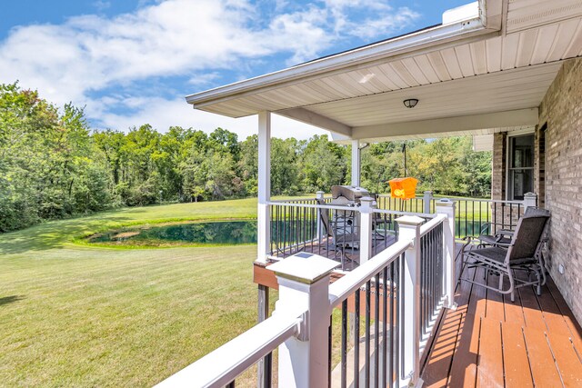 wooden deck featuring a yard