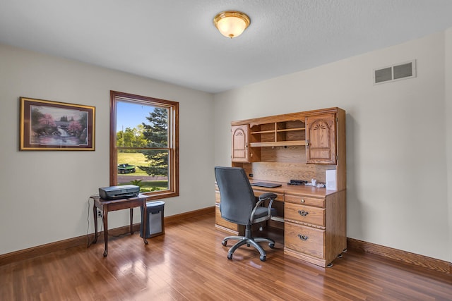 home office with hardwood / wood-style floors