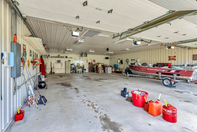 garage with a workshop area and a garage door opener