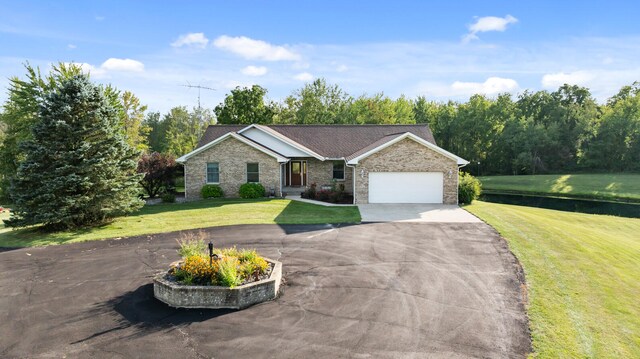 single story home featuring a garage and a front lawn