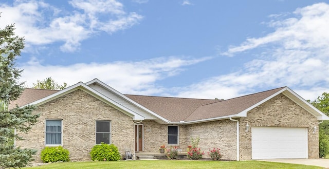 single story home featuring a front yard and a garage