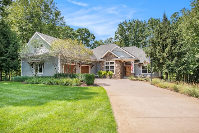 view of front of property featuring a front yard and a garage