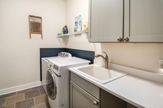 laundry room featuring sink, dark tile patterned flooring, cabinets, and washing machine and clothes dryer