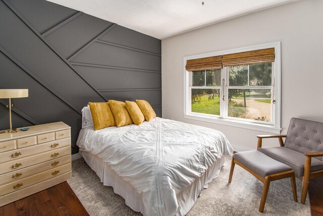 bedroom with dark hardwood / wood-style floors