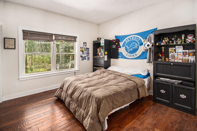 bedroom with dark wood-type flooring