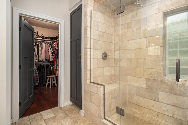 bathroom featuring hardwood / wood-style floors and walk in shower