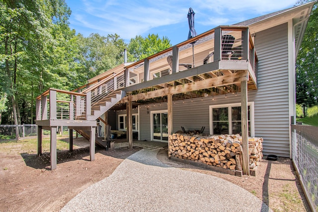 back of house featuring a patio and a deck