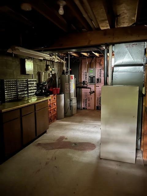 basement with a workshop area and gas water heater