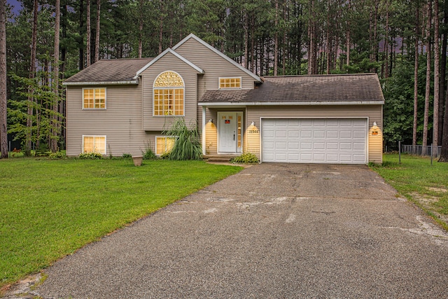 view of front facade featuring a front yard and a garage