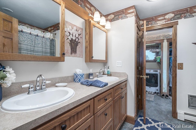 full bath featuring a sink, baseboards, baseboard heating, and double vanity