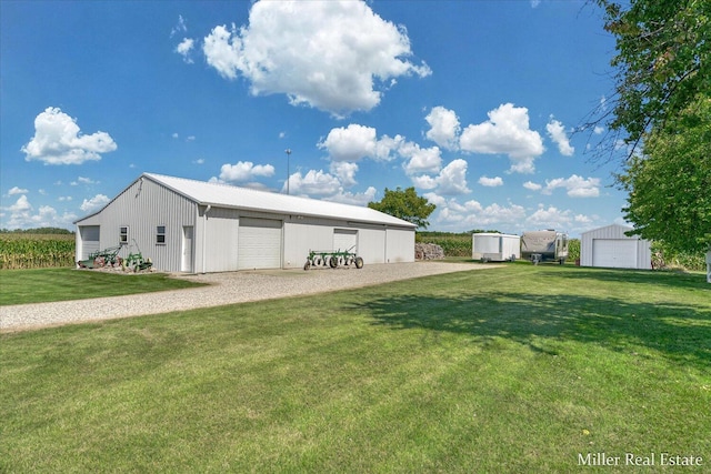 exterior space with an outdoor structure, a garage, and a pole building